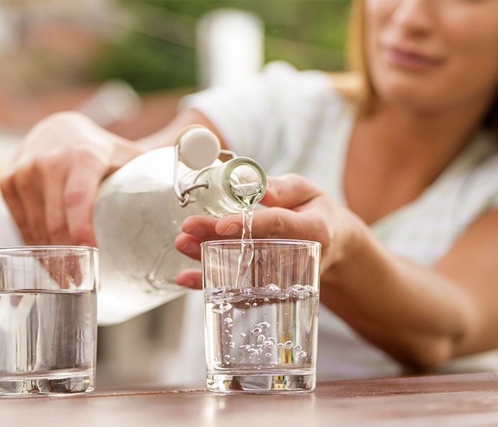 Woman pouring a glass of water